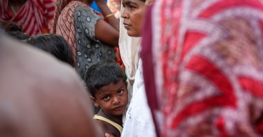 A boy stands with his mother inside a makeshift shelter camp in Goalpara district in the northeastern state of Assam, India, July 18, 2025. (Reuters Photo)