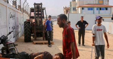 A Palestinian youth who was injured by Israel while seeking humanitarian aid at the Rafah corridor, is carried into the Red Cross field hospital in the Mawasi area of Rafah in the southern Gaza Strip, July 28, 2025. (AFP Photo)