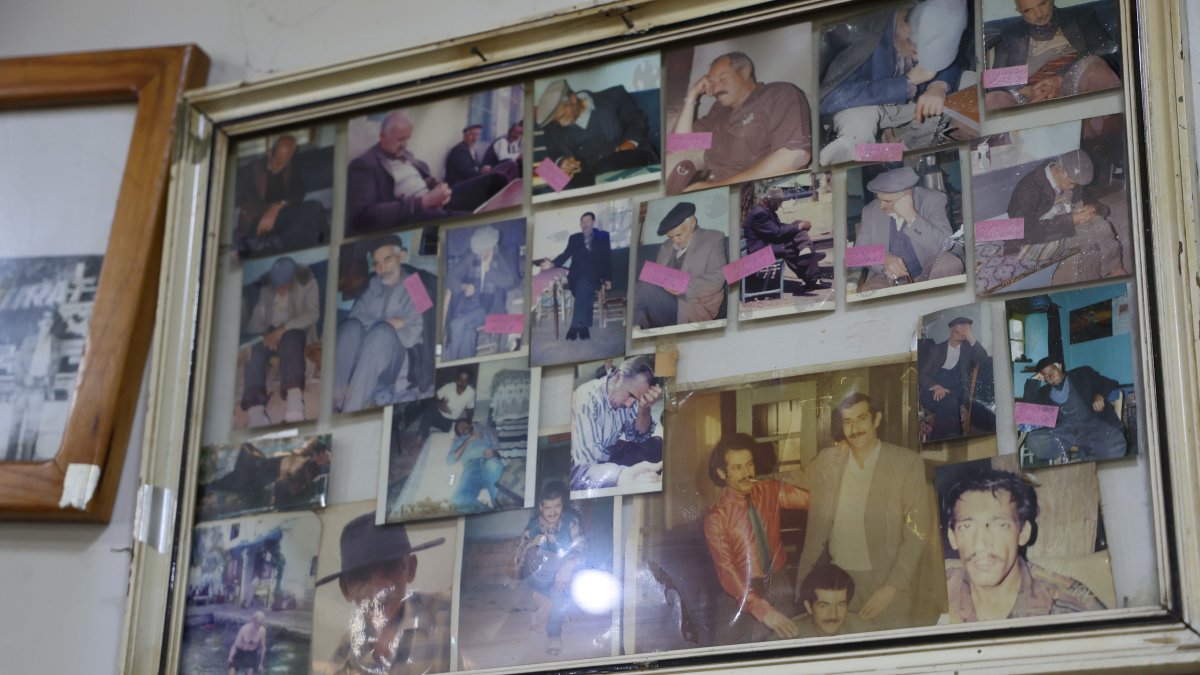 Photos of visitors sleeping hang on the wall inside the cafe in Yukarı Içme village, Elazığ, Türkiye, July 29, 2025. (IHA Photo)