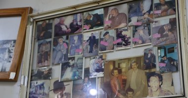 Photos of visitors sleeping hang on the wall inside the cafe in Yukarı Içme village, Elazığ, Türkiye, July 29, 2025. (IHA Photo)