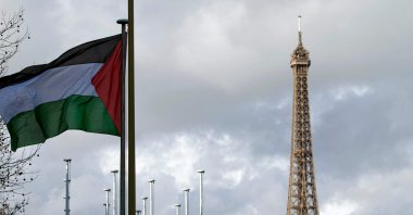 The Palestinian flag is raised for the first time (with the Eiffel Tower in the background) above the UNESCO headquarters, Paris, France, Dec. 13, 2011. (AFP Photo)
