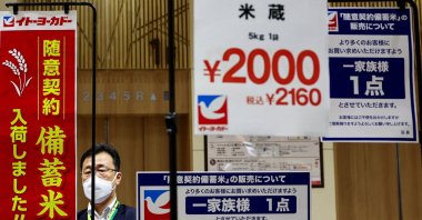A man prepares banners before the sale of government-stockpiled rice aimed at resolving persisting price rises, at a Ito-Yokado grocery store, a subsidiary of Seven &amp; i Holdings, Tokyo, Japan, May 31, 2025. (Reuters Photo)