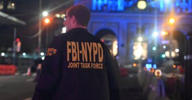 A member of the FBI-NYPD joint task force inspects the scene of a mass shooting in New York, U.S., July 28, 2025. (AA Photo)