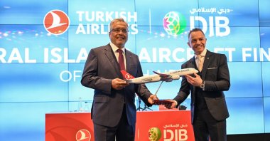 Turkish Airlines Chairperson Ahmet Bolat (L) and Adnan Chilwan, group CEO at Dubai Islamic Bank, pose for photos after a signing ceremony, Istanbul, Türkiye, July 28, 2025. (AA Photo)