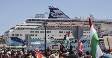 Pro-Palestinian protesters gather during the arrival of a ship carrying Israeli tourists in Agios Nikolaos port, on the island of Crete, Greece, Tuesday, July 29, 2025. (AP Photo)