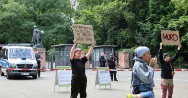 Demonstrators stand with protest signs in front of the Nuremberg Zoo in Nuremberg, Germany, Tuesday, July 29, 2025. (Daniel Loeb/dpa via AP)