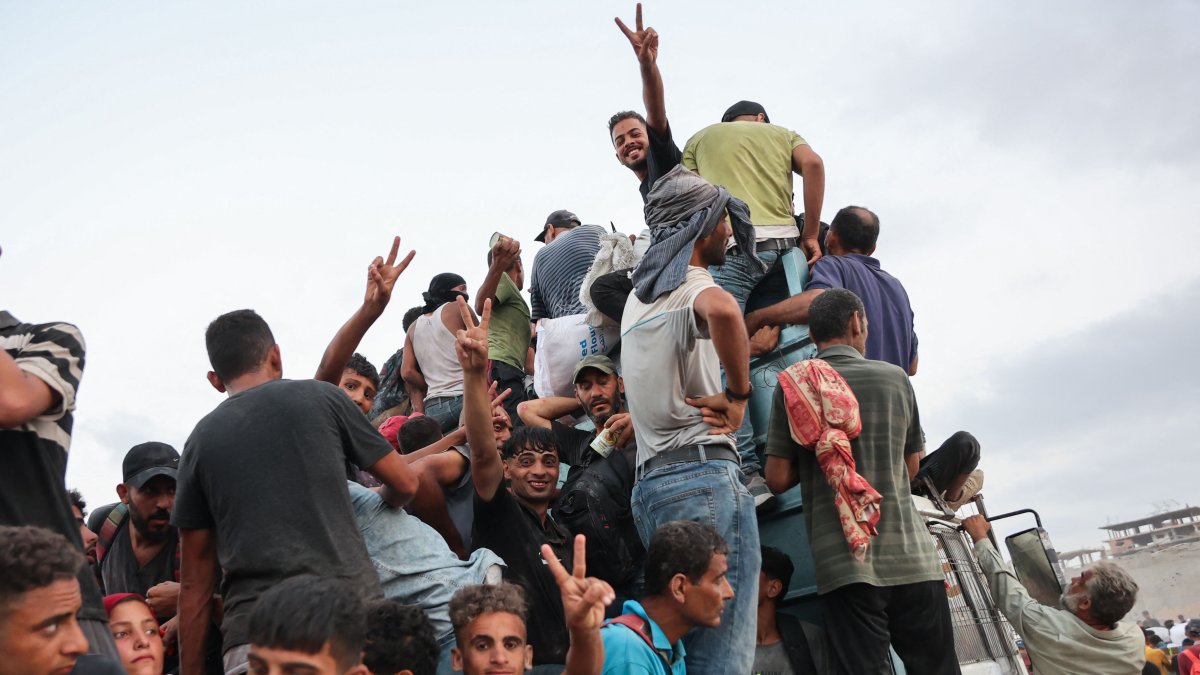 Palestinians climb in the back of a truck on a coastal path west of Beit Lahia, Gaza, Palestine, July 29, 2025. (AFP Photo)