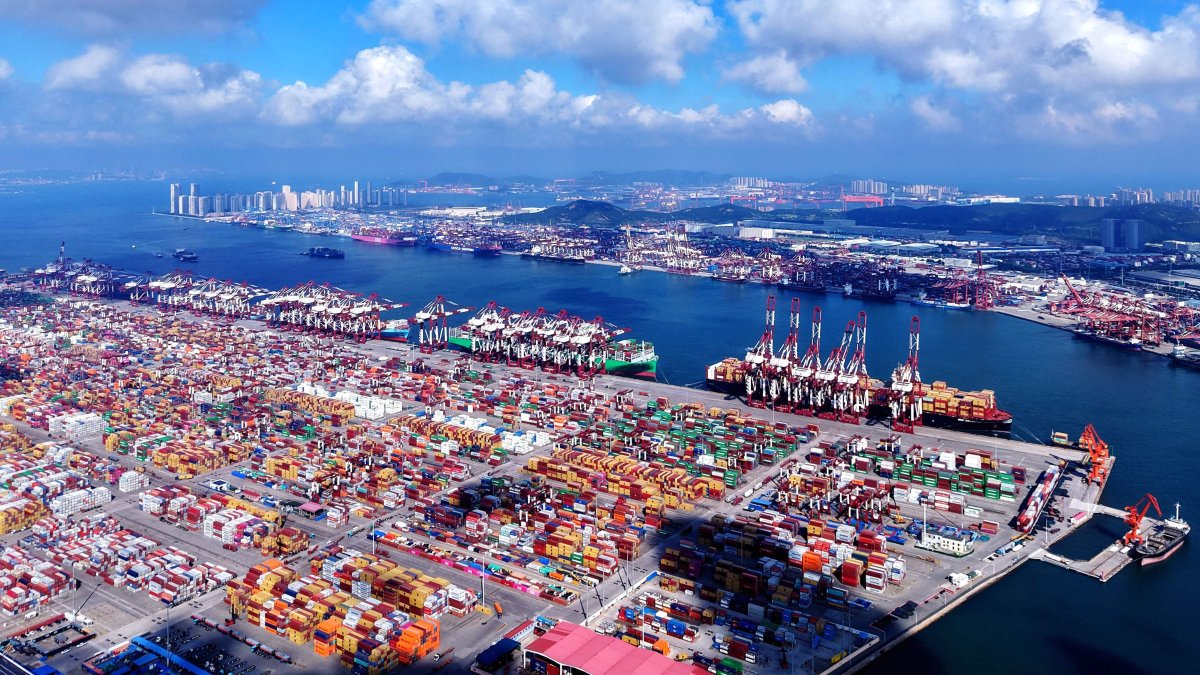 Containers and ships are seen at the port in Qingdao, Shandong province, eastern China, July 25, 2025. (AFP Photo)