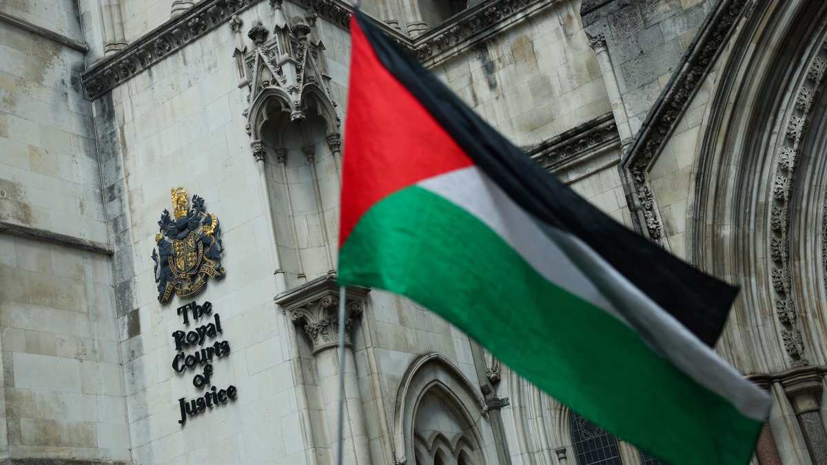 A person holds a Palestinian flag outside the High Court in London, U.K., July 21, 2025. (Reuters Photo)
