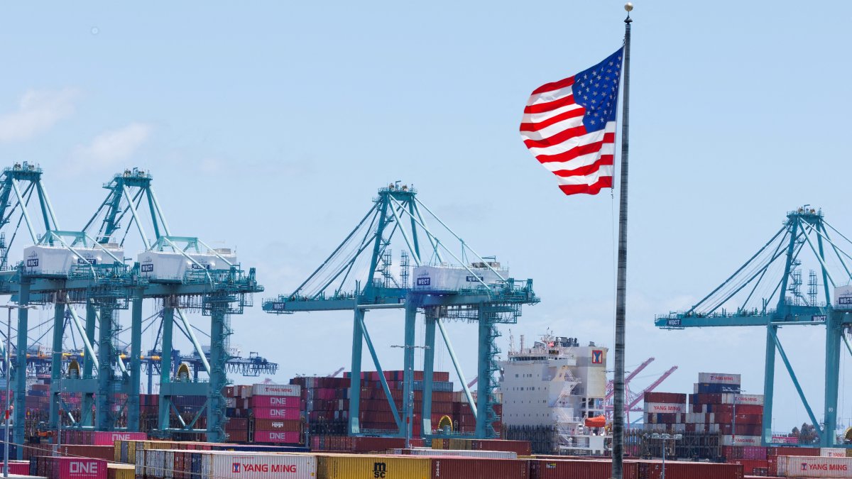 An American flag flutters over a ship and shipping containers at the Port of Los Angeles, in San Pedro, California, U.S., May 13, 2025. (Reuters Photo)