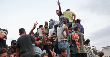Palestinians climb in the back of a truck on a coastal path west of Beit Lahia, Gaza, Palestine, July 29, 2025. (AFP Photo)