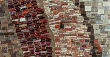 An aerial view shows handwoven carpets laid out in the open fields to soften their colours under the sizzling sun, Antalya, Türkiye, July 22, 2025.  (AFP Photo)
