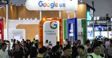 People walk past a Google stand during the World Artificial Intelligence Conference (WAIC) at the Shanghai World Expo and Convention Center, Shanghai, China, July 28, 2025. (AFP Photo)