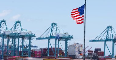 An American flag flutters over a ship and shipping containers at the Port of Los Angeles, in San Pedro, California, U.S., May 13, 2025. (Reuters Photo)