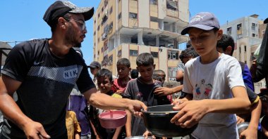 Palestinians gather to receive food from a charity kitchen, amid a hunger crisis, in Nuseirat, Gaza Strip, Palestine, July 29, 2025. (Reuters Photo)