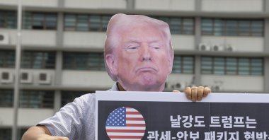 A protester wears a mask depicting U.S. President Trump during a rally against U.S. President Trump&#039;s policy on South Korea, near the U.S. Embassy, Seoul, South Korea, July 30, 2025. (EPA Photo)
