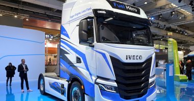 Members of the media stand behind an Iveco S-Way truck at the booth of truck-maker Iveco at the IAA Transportation fair, Hanover, Germany, Sept. 19, 2022. (Reuters Photo)