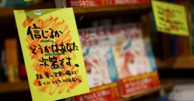 A sales banner written by the store, reading &quot;Whether you believe it or not is up to you,&quot; is displayed next to the comic book titled &quot;The Future I Saw,&quot; authored by manga artist Ryo Tatsuki, on the shelf at the bookstore Village Vanguard, Tokyo, Japan, June 30, 2025. (Reuters Photo)