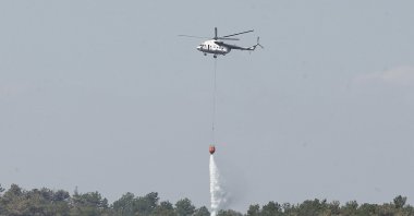 A helicopter assists firefighting efforts as the forest fire between Bursa’s Orhaneli and Harmancık districts enters its fifth day of containment, Bursa, Türkiye, July 30, 2025. (AA Photo)