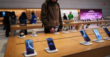 A person looks at iPhones in the Apple Fifth Avenue store in New York City, U.S., May 23, 2025. (Reuters Photo)