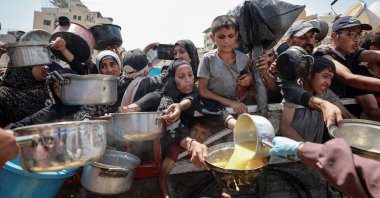 Palestinians gather to receive food from a charity kitchen, amid a hunger crisis, Gaza City, Palestine, July 28, 2025. (Reuters Photo)