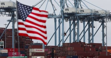 A U.S. flag flutters in front of shipping containers at the Port of Long Beach in Long Beach, California, U.S., July 11, 2025. (Reuters Photo)