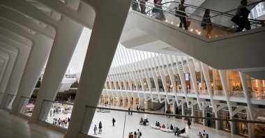 People make their way through the Oculus World Trade Center transportation hub and shopping mall on July 15, 2025. (AFP Photo)