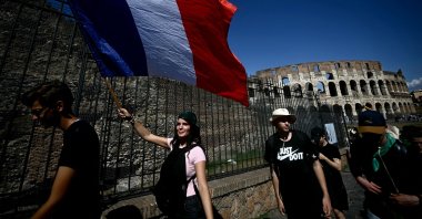A pilgrim waves a flag of France as she walks away from the Colosseum during the Vatican&#039;s Jubilee of Youth in Rome, Italy, July 31, 2025. (AFP Photo)