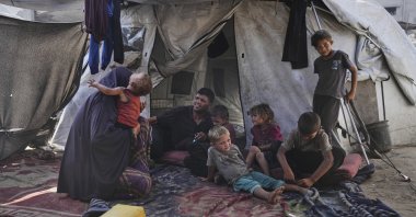 Abeer and Fadi Sobh gather in their tent with their children at a camp for displaced Palestinians in Gaza City, July 24, 2025. (AP Photo)