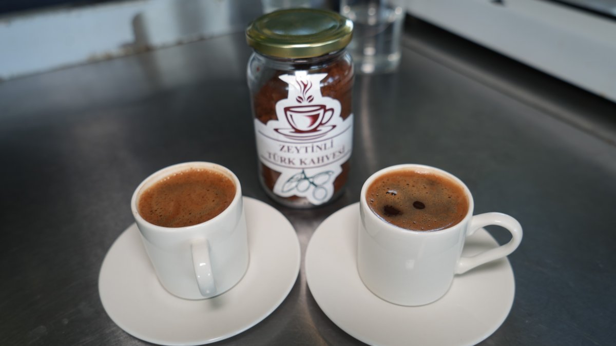 Two cups of freshly brewed Turkish coffee sit beside a box of olive-infused Turkish coffee, Ayvalık, Türkiye, Aug. 3, 2025. (IHA Photo)