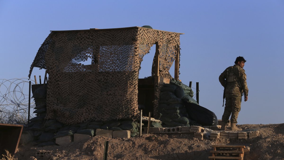 A YPG terrorist stands inside a post in Tal Abyad, Syria, Oct. 7, 2019. (AP Photo)