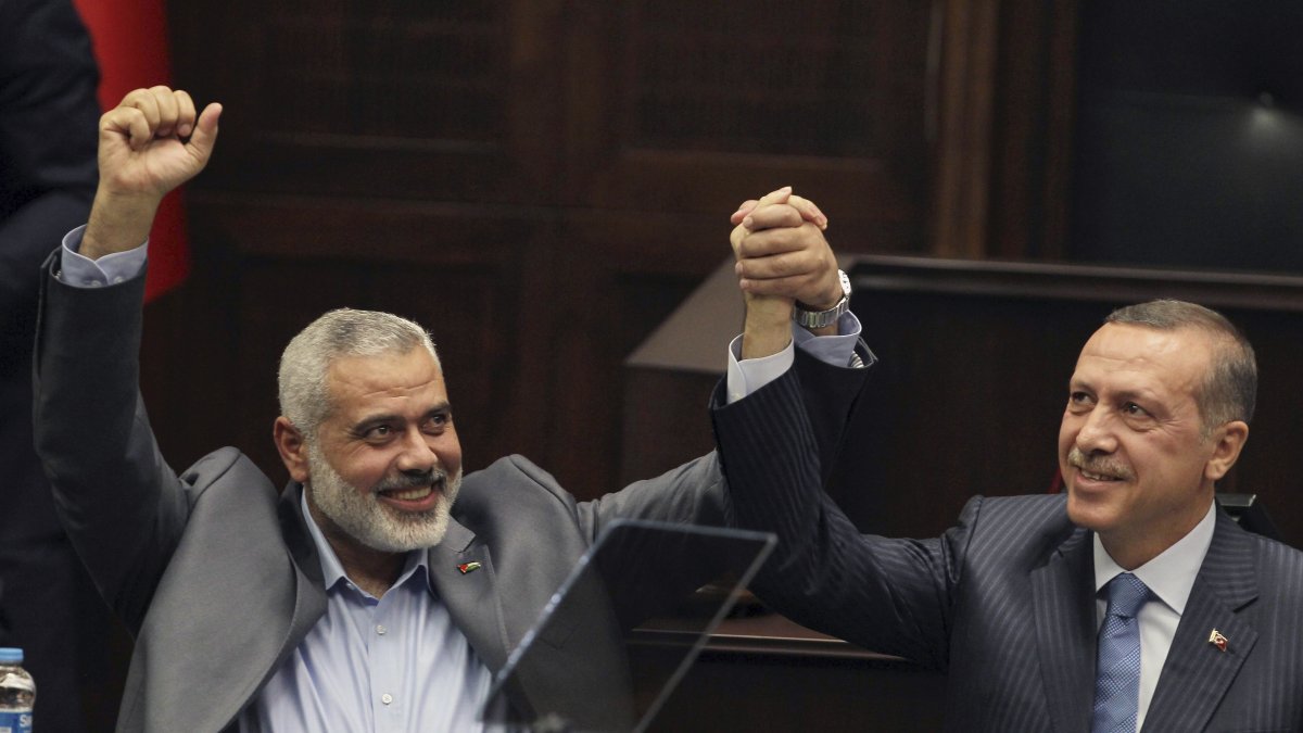 President Recep Tayyip Erdoğan, then prime minister, saluted lawmakers with late Hamas leader Ismail Haniyeh, Ankara, Türkiye, Jan. 3, 2012. (AP Photo)