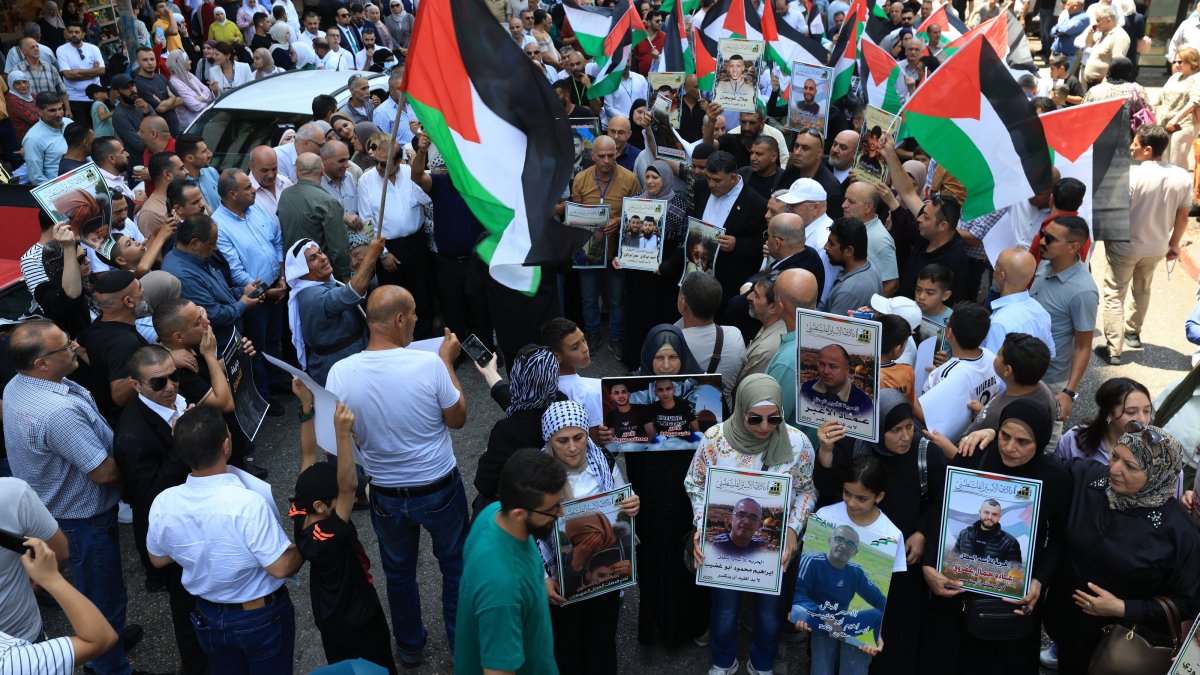 Palestinians carrying placards and waving flags take part in a protest against the ongoing war in the Gaza Strip, in the West Bank city of Nablus, Palestine, Aug. 3, 2025. (EPA Photo) 