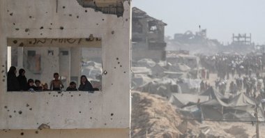 Women and children look out from a damaged building as Palestinians carry aid supplies, Beit Lahia, northern Gaza Strip, Palestine, Aug. 2, 2025. (Reuters Photo)