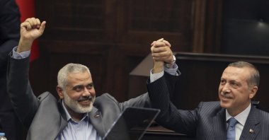 President Recep Tayyip Erdoğan, then prime minister, saluted lawmakers with late Hamas leader Ismail Haniyeh, Ankara, Türkiye, Jan. 3, 2012. (AP Photo)