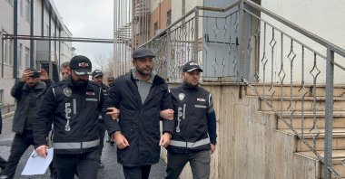 Police officers escort Beşiktaş Mayor Rıza Akpolat for a medical check after his detention, Istanbul, Türkiye, Jan. 13, 2025. (IHA Photo)
