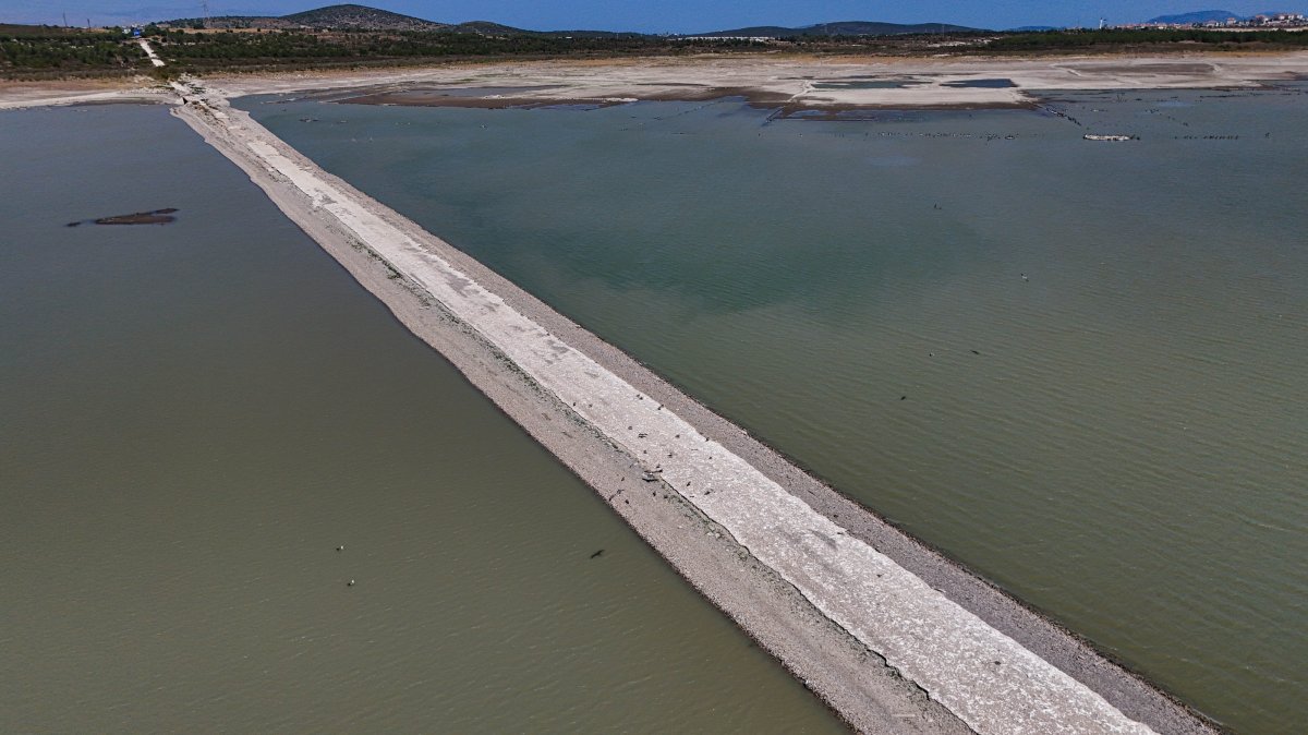 A section of the old Izmir-Çeşme highway emerges as water levels drop at the Alaçatı Kutlu Aktaş Dam, captured by drone, Izmir, Türkiye, Aug. 3, 2025.