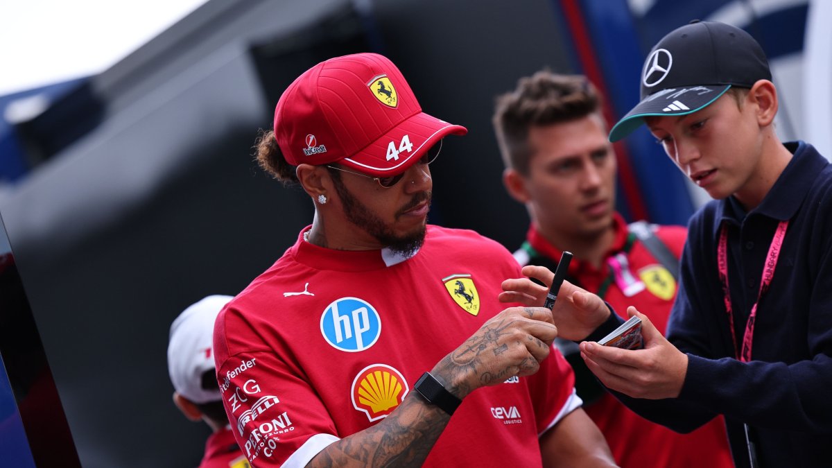 Scuderia Ferrari driver Lewis Hamilton of Britain signs an autograph as he arrives at the drivers' parade before the Formula One Hungarian Grand Prix at the Hungaroring racetrack in Mogyorod, Budapest, Hungary, Aug. 3, 2025. (EPA Photo)