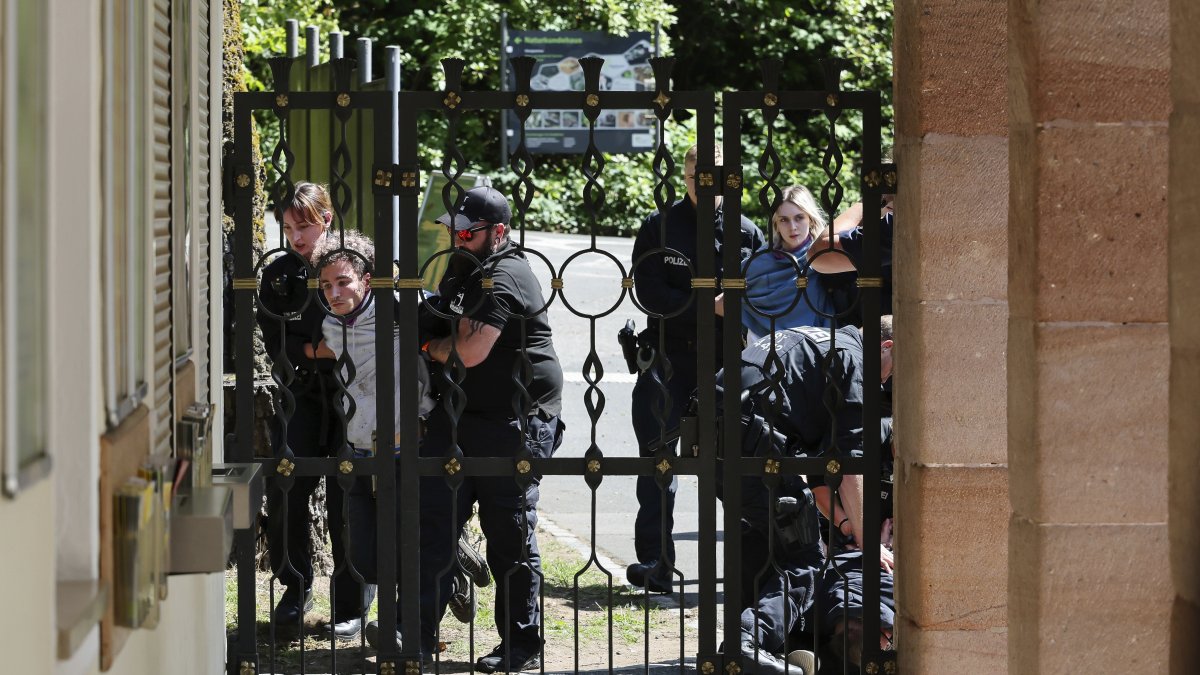 Demonstrators from Animal Rebellion are arrested by the police after entering the grounds of the Nuremberg Zoo in Nuremberg, Germany, Tuesday, July 29, 2025. (Daniel Loeb/dpa via AP)