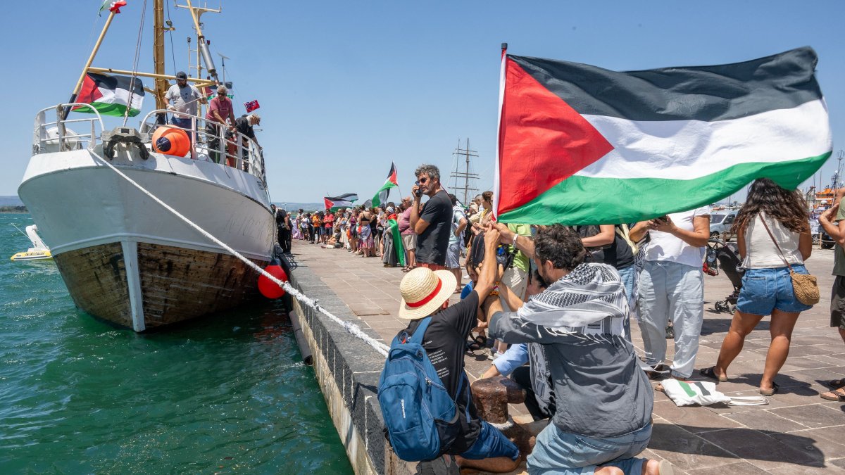 People gather with Palestinian flags around the Freedom Flotilla ship &quot;Handala&quot; ahead of the boat&#039;s departure for Gaza at a port in Syracuse, Sicily, southern Italy, July 13, 2025. (AFP Photo)
