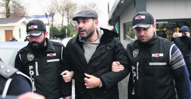Police officers escort Rıza Akpolat after his arrest, Istanbul, Türkiye, Jan. 13, 2025. (AA Photo)