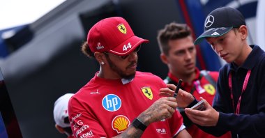 Scuderia Ferrari driver Lewis Hamilton of Britain signs an autograph as he arrives at the drivers' parade before the Formula One Hungarian Grand Prix at the Hungaroring racetrack in Mogyorod, Budapest, Hungary, Aug. 3, 2025. (EPA Photo)