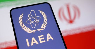 The International Atomic Energy Agency (IAEA) logo and the Iranian flag are seen in this illustration taken June 16, 2025. (Reuters Photo)