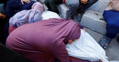 The mother of Palestinian Mohammed Al-Motawak, who was killed by Israeli fire while trying to receive aid on Sunday, mourns over his body during his funeral at Al-Shifa Hospital, Gaza City, Palestine, Aug. 4, 2025. (Reuters Photo)