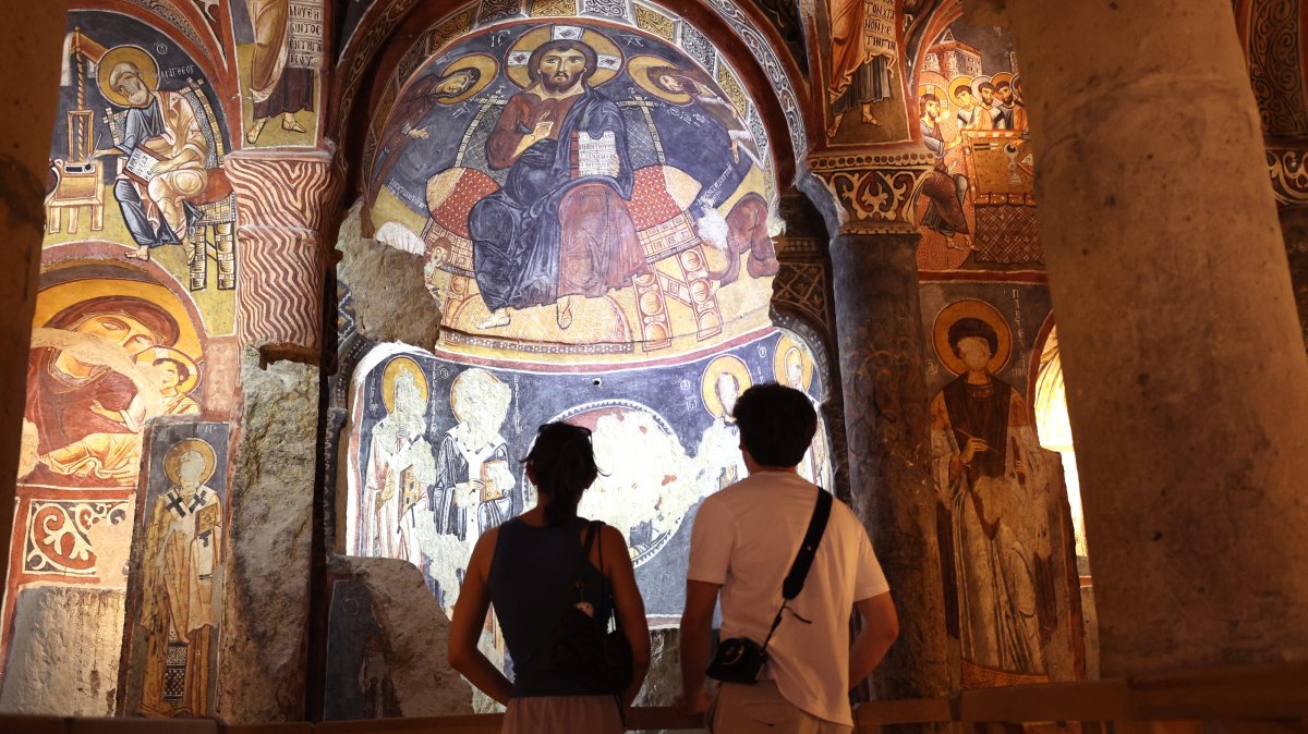 Visitors explore the frescoes of the Dark Church in Cappadocia, Nevşehir, central Türkiye, Aug. 1, 2025. (AA Photo)