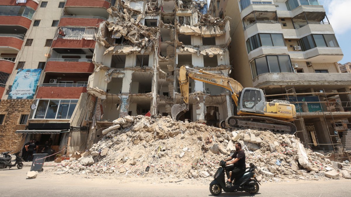 A man rides on a motorbike past a building damaged during Israeli attacks in the southern city of Tyre, Lebanon July 3, 2025. (Reuters Photo)