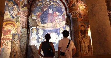 Visitors explore the frescoes of the Dark Church in Cappadocia, Nevşehir, central Türkiye, Aug. 1, 2025. (AA Photo)