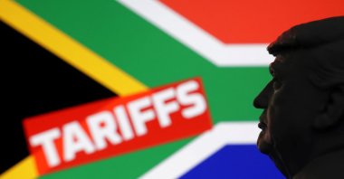 A 3D-printed miniature model of U.S. President Donald Trump, the South African flag and the word "Tariffs" are seen in this illustration taken July 23, 2025. (Reuters Photo)