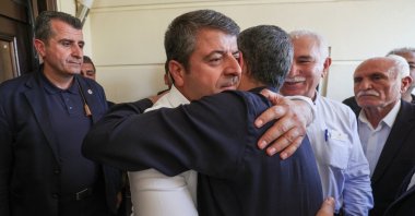 Abdurrahman Tutdere (L) hugs Republican People’s Party (CHP) Chair Özgür Özel during a meeting, Adıyaman, southeastern Türkiye, July 13, 2025. (DHA Photo)