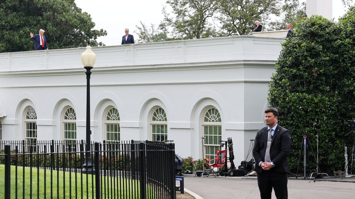 U.S. President Donald Trump waves from the roof as he gets a different view of the proposed ballroom site at the White House in Washington, U.S., Aug. 5, 2025. (Reuters Photo)